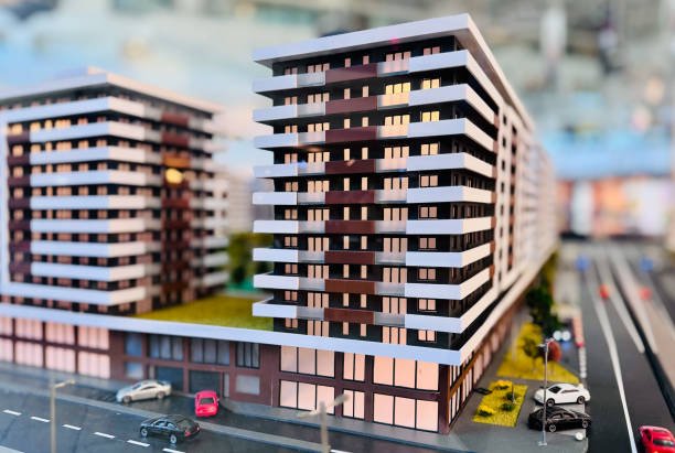 A miniature model of a residential complex displaying multiple buildings and green spaces.